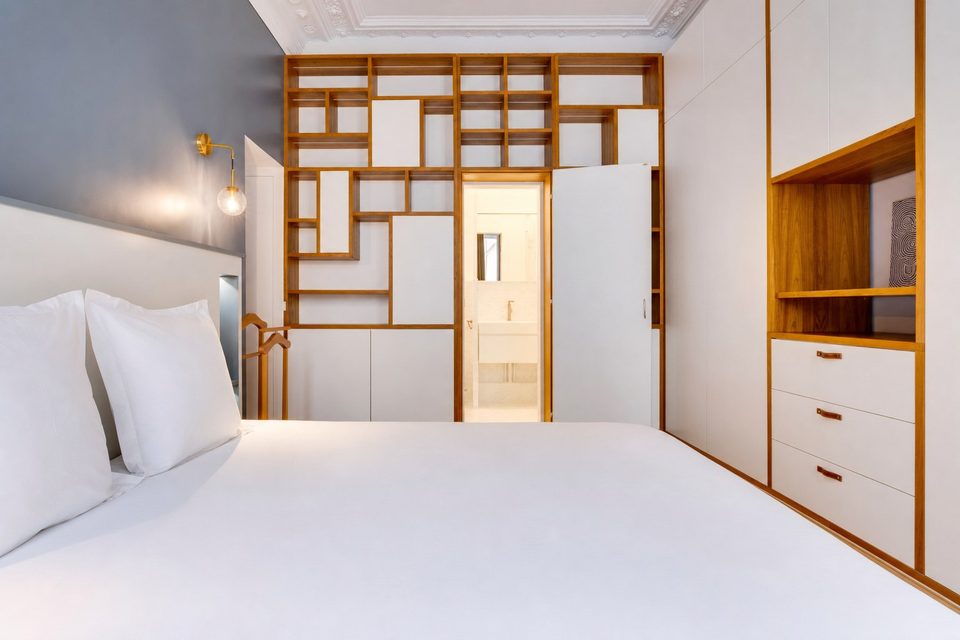 Primary bedroom — custom maple bibliothèque with hidden passage to the Calacatta en-suite