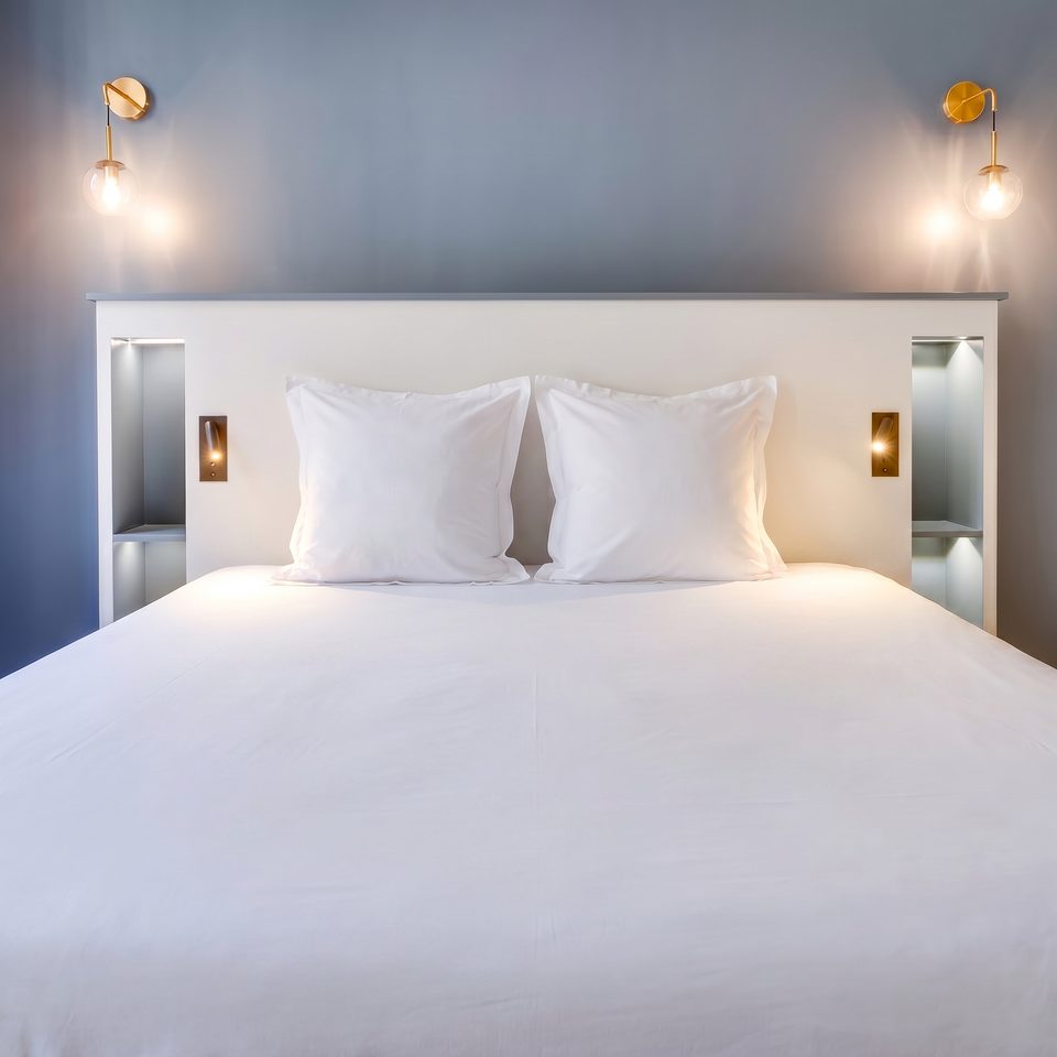 Primary bedroom headboard — brass sconces, integrated niches, bleu d'encre walls