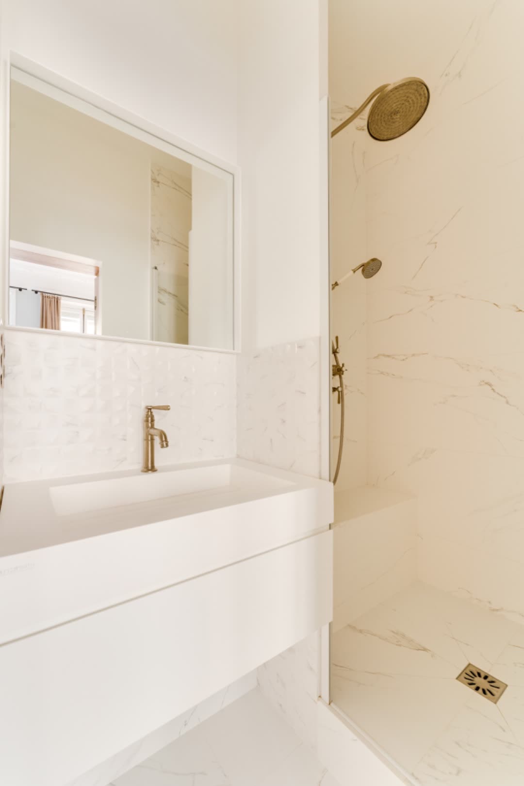 Second en-suite bath — Calacatta marble walls, brushed brass fittings and walk-in shower