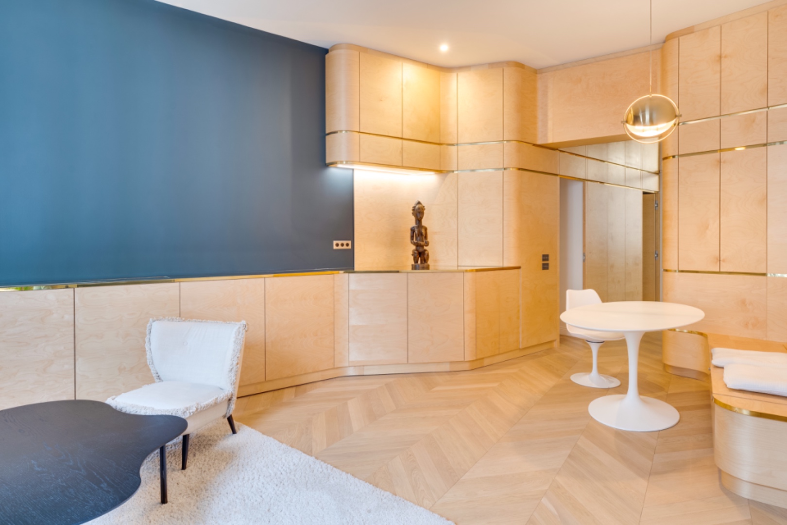 Architect-designed kitchen with maple millwork, brass inlays, and a sculptural piece