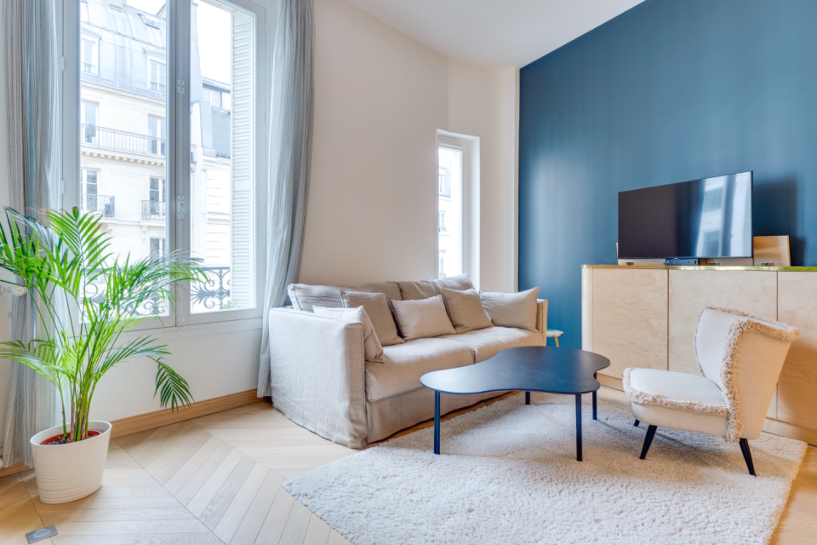 Light-filled salon with Haussmannian windows over Place Monsigny